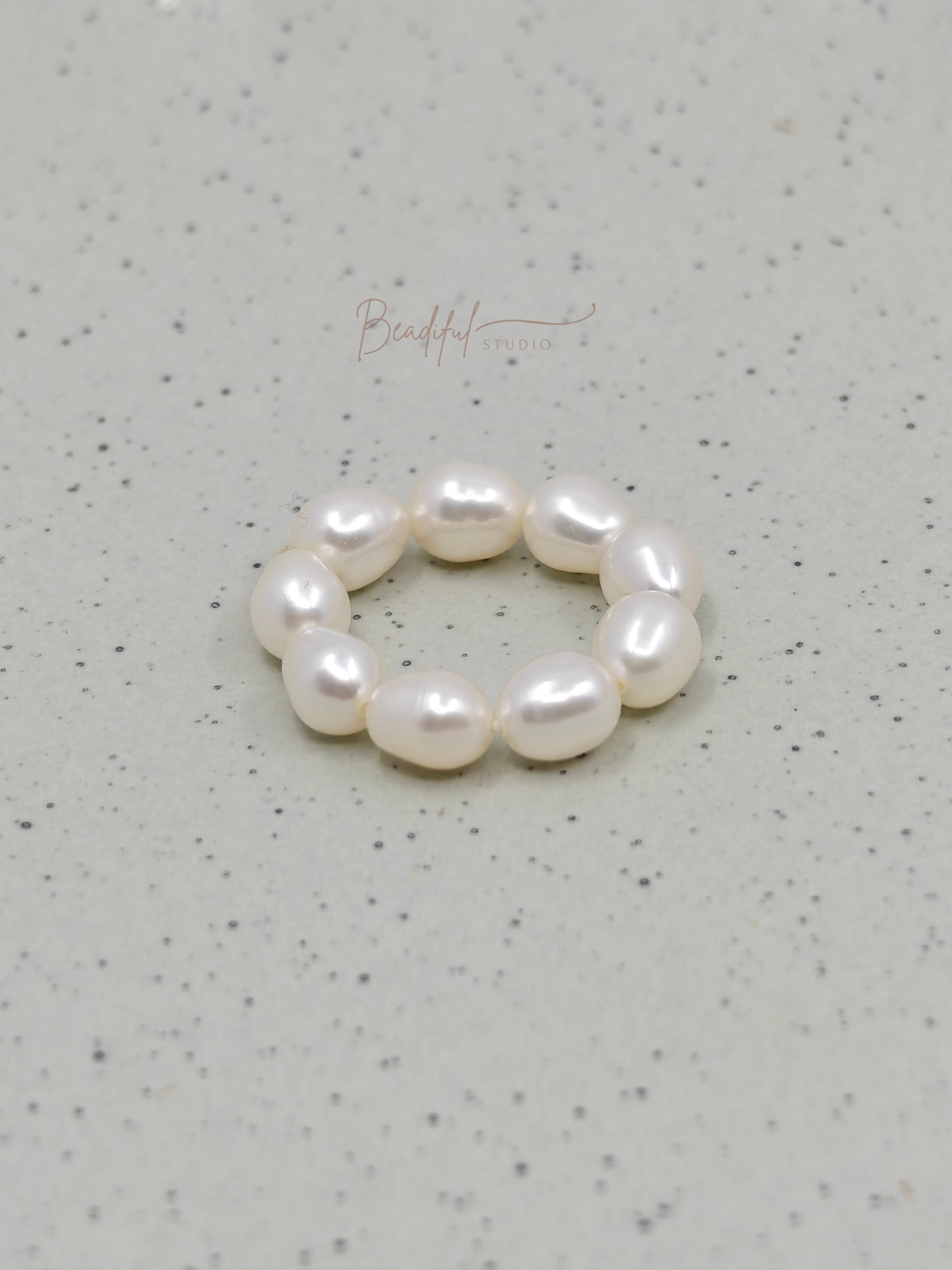 Image of the pearl ring laying flat on a surface 