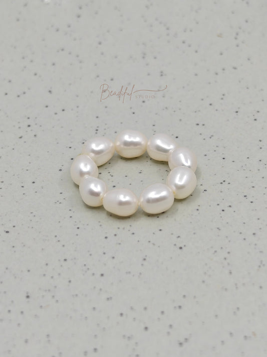 Image of the pearl ring laying flat on a surface 