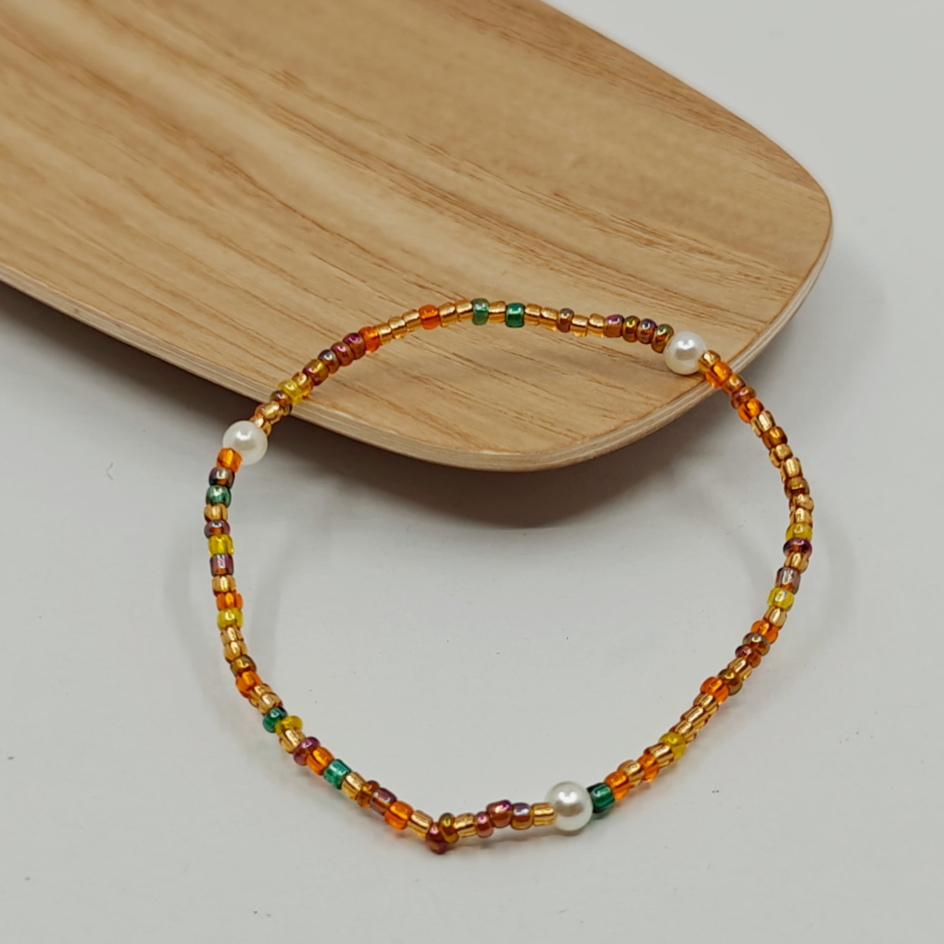 Picture of the bracelet placed on a corner of a jewelry dish.