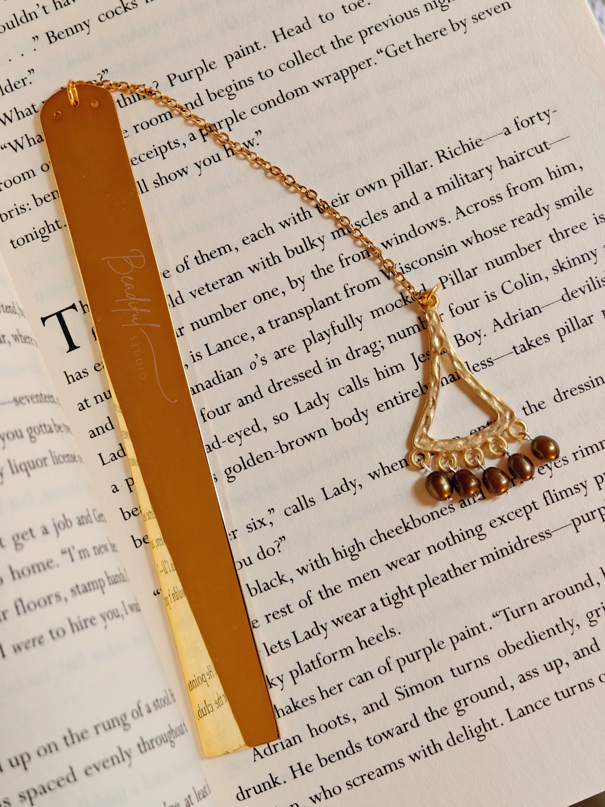 A close-up image of the Celeste bookmark laying flat on a page of a book.