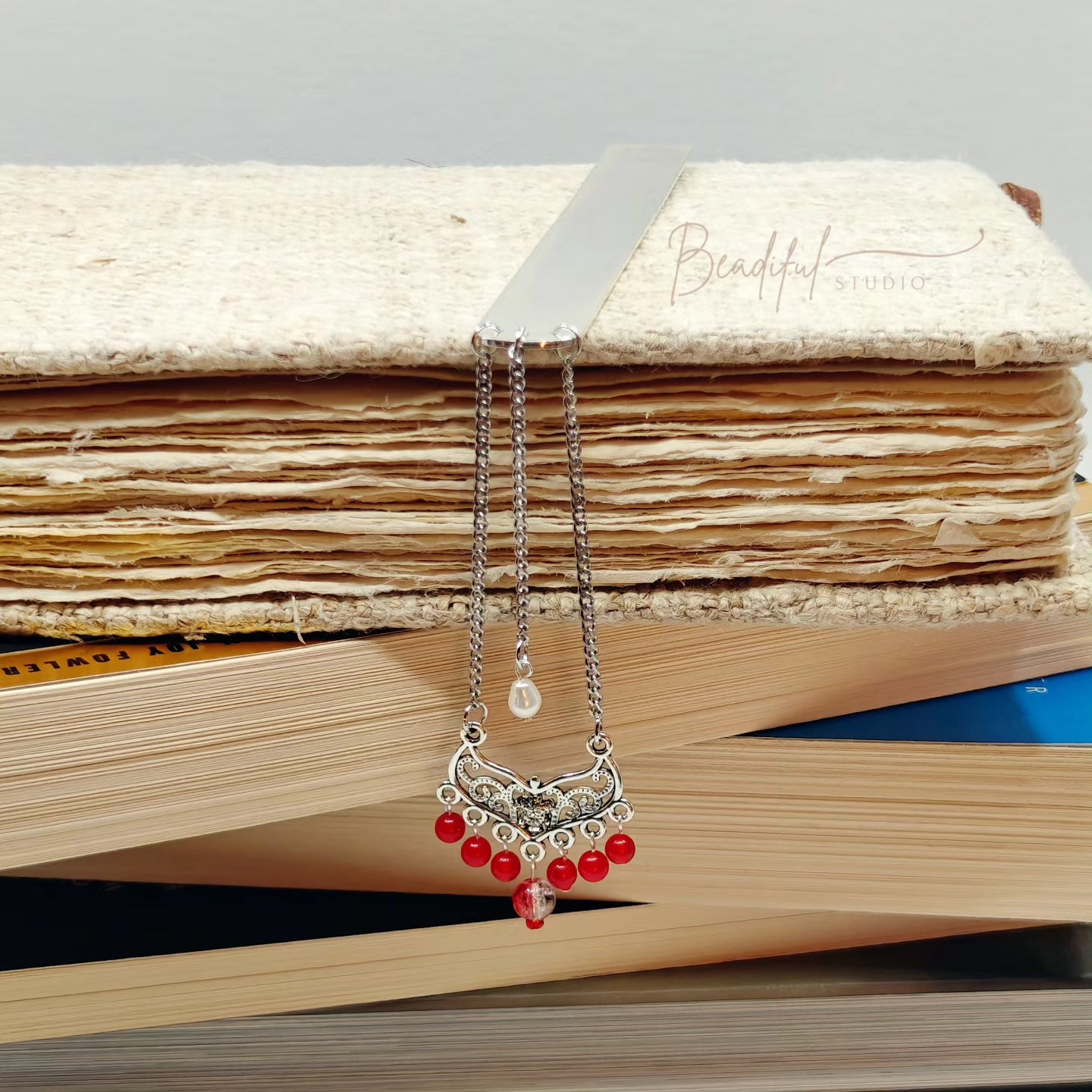 Image of the bookmark dangling off the side of a pile of stacked books.