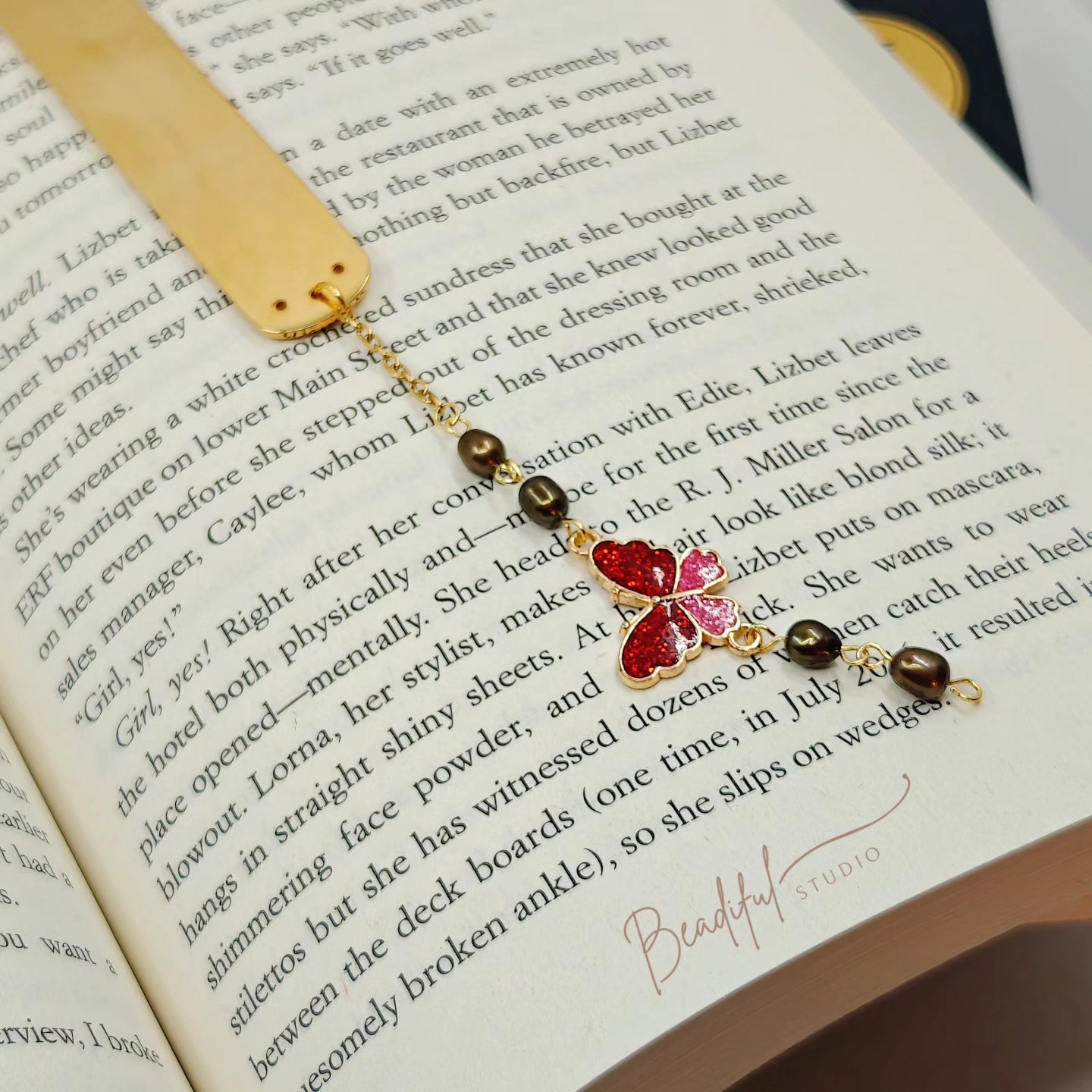 Image of the Aurora bookmark laying flat on the page of an opened book.